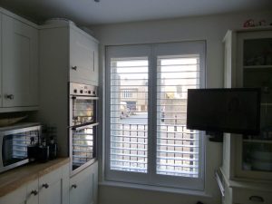 Full Height Plantation Shutters In Window Next To Kitchen Oven