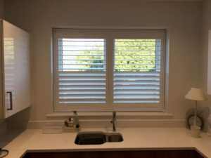 Full Height White Shutters Above Sink In Kitchen
