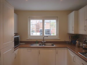 White Louvered Shutters On Kitchen Window