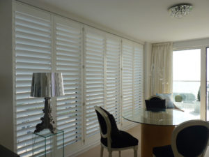 White Tracked Shutters On Patio Doors