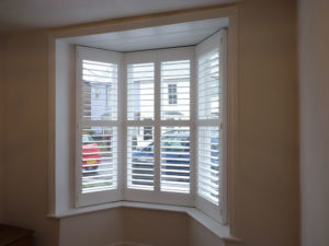 Four Panel Angled Bay Window With White Shutters