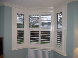 White Plantation Shutters In Angled Bay Window
