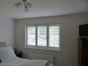 Bedroom Window With White Shutter Blinds