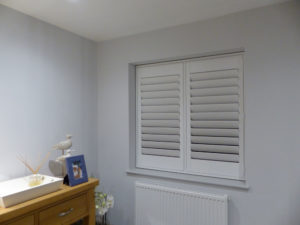White Shutter Blind With TPost In Two Panel Window