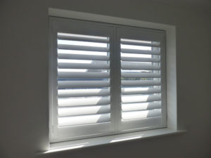 White Shutters In Small Two Panel Window